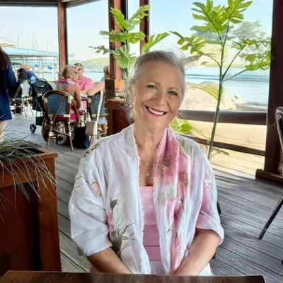 Ramona Troy, Commercial Insurance Director at Gatta Insurance, smiling at a waterside restaurant
